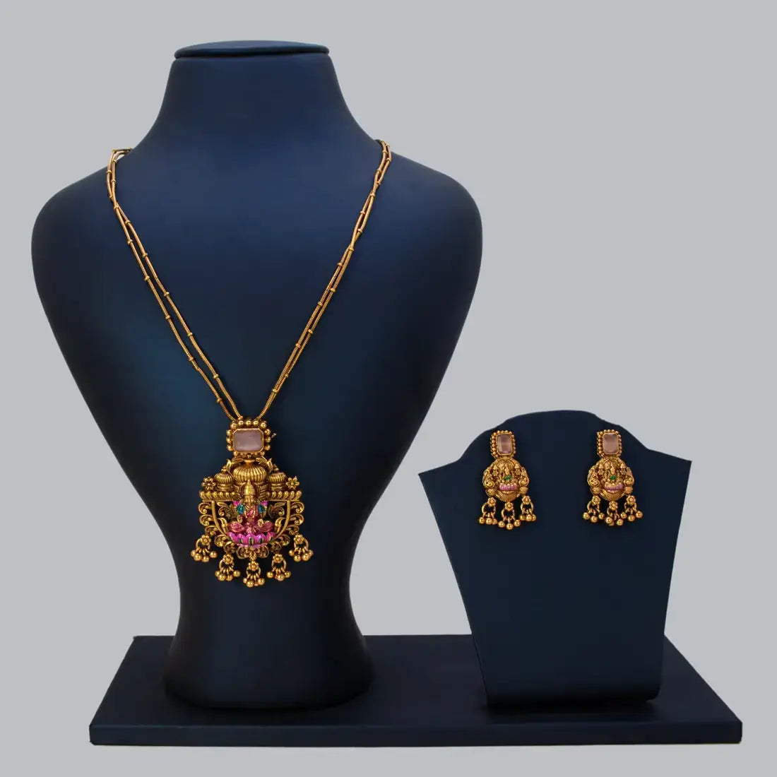 Pink Stone Antique Lakshmi Pendant Necklace Set displayed on a mannequin with matching earrings.