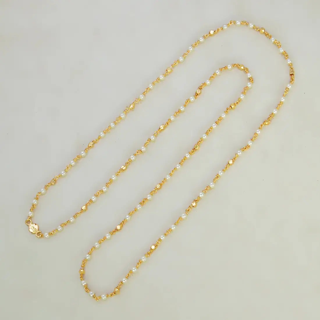 Gold Plated Pearl Mala Chain featuring shiny white pearls and delicate gold accent beads for a luminous look.