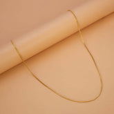 Gold Plated Nice Kilukkam Box Chain - 18" elegantly displayed on a textured surface.