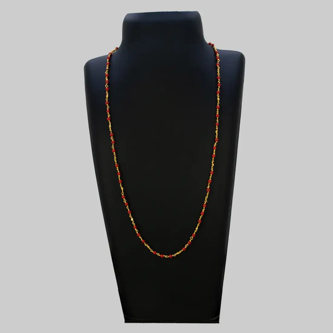 Gold Plated Coral Red Beads Chain displayed on a necklace bust, showcasing vibrant coral-red beads and gold accents.