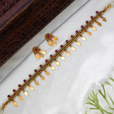 Antique Gold Plated Curb Link Elakkathali Choker Set with gold leaf danglers and ruby-toned kemp stones.