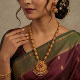 Antique Temple Floral Kemp Stone Long Chain Set worn by a model, showcasing the ornate necklace and jhumka earrings.