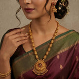 Antique Temple Floral Kemp Stone Long Chain Set worn by a model, showcasing the ornate necklace and jhumka earrings.