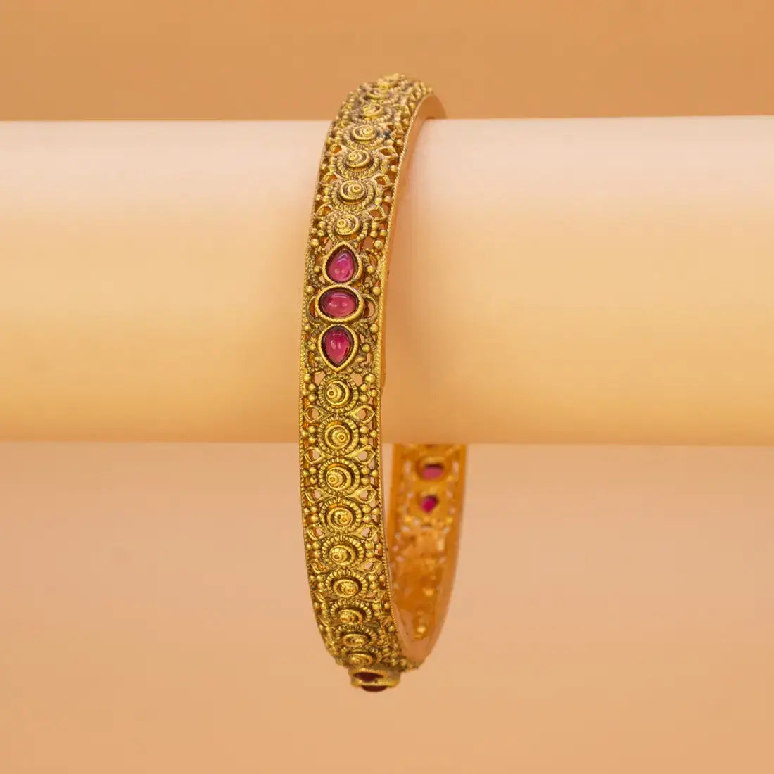 Antique Gold Plated Kemp Stone Kada Bangle showcasing intricate design and ruby red stones.