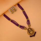 Antique Gold Lakshmi Pendant Beaded Long Necklace Set with purple beads and matching jhumka earrings.