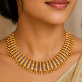 Antique Gold Plated Broad Matte Finish Ruby Necklace showcased on a woman, highlighting intricate craftsmanship and vibrant rubies.