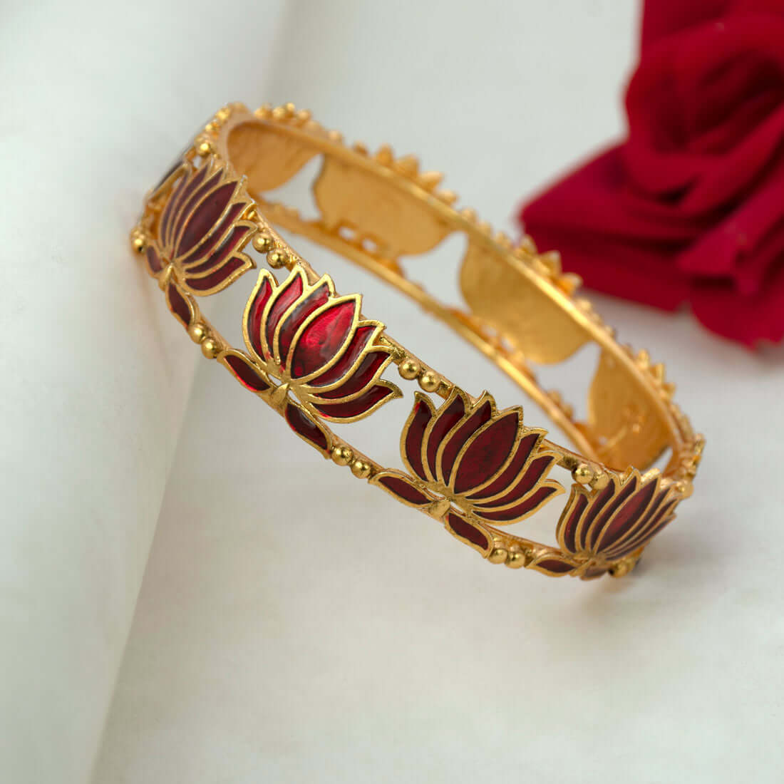Matte Gold Plated Lotus Enamel Bangle with intricate dark red lotus motifs and rich detailing.