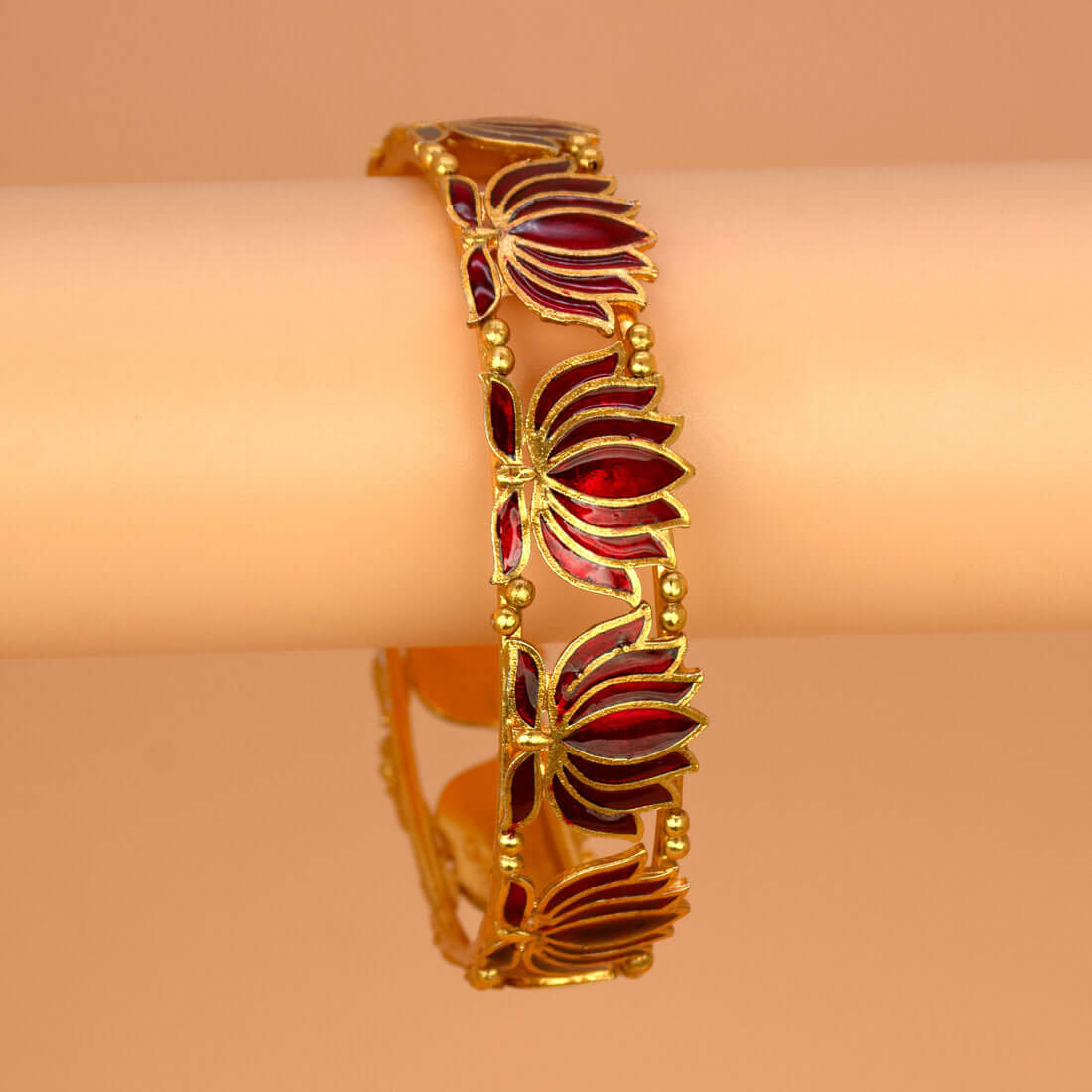 Matte Gold Plated Lotus Enamel Bangle showcasing intricate lotus motifs and rich enamel in dark red.