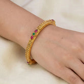 Antique Matte Kemp Multi Colour Stone Bangle worn on a wrist, showcasing its intricate design and vibrant stones.