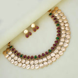Antique Kemp Stone Lakshmi Kasu Choker Set featuring kemp stones and Lakshmi coins on a marble background.
