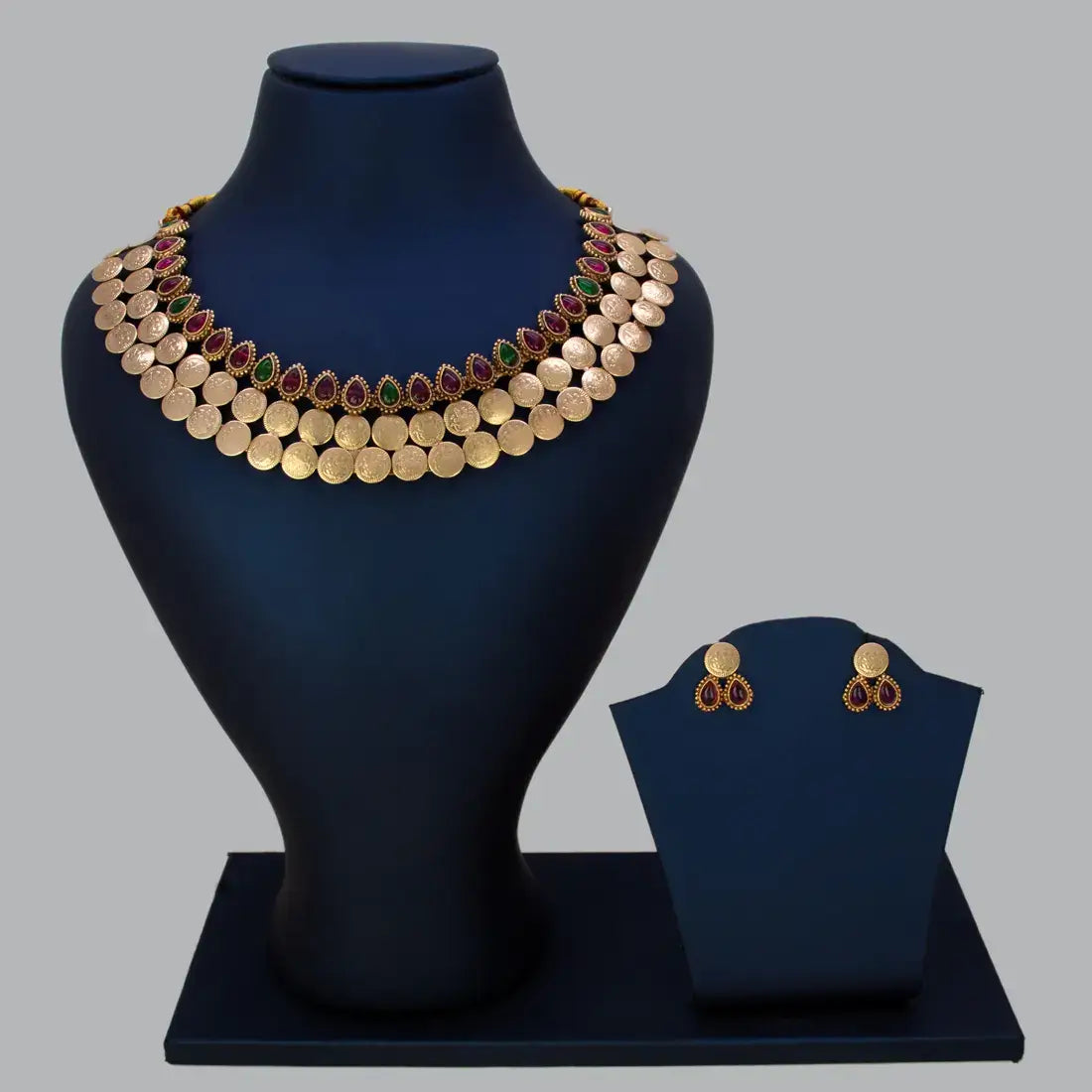 Antique Kemp Stone Lakshmi Kasu Choker Set displayed on a bust with matching earrings, showcasing vibrant kemp stones.
