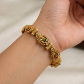 Antique Multi-colour Kemp Stone Peacock Bangle on wrist, showcasing red and green stones with intricate peacock design.