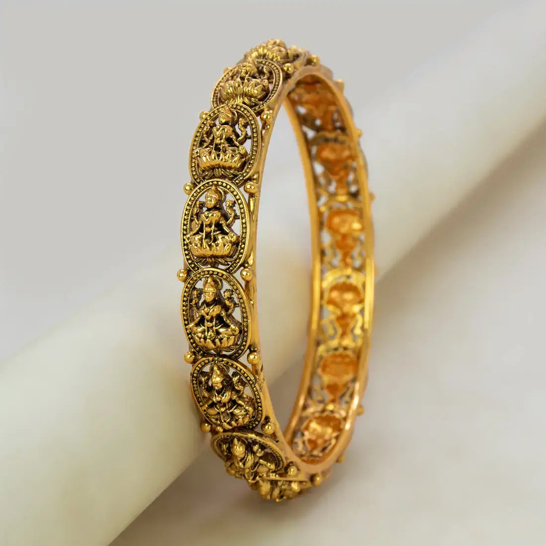 Antique Gold Plated Lakshmi Kada Bangle featuring intricate carvings of Goddess Lakshmi on a lotus.