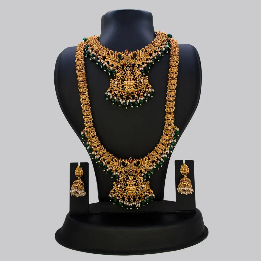 Antique Green Beads Lakshmi Bridal Jewellery Set displayed elegantly on a bust showcasing intricate gold detailing and green beads.