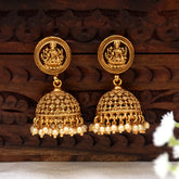 Antique Matte Lakshmi Temple Jhumka earrings with pearls, featuring a detailed Goddess Lakshmi motif in antique gold-tone.