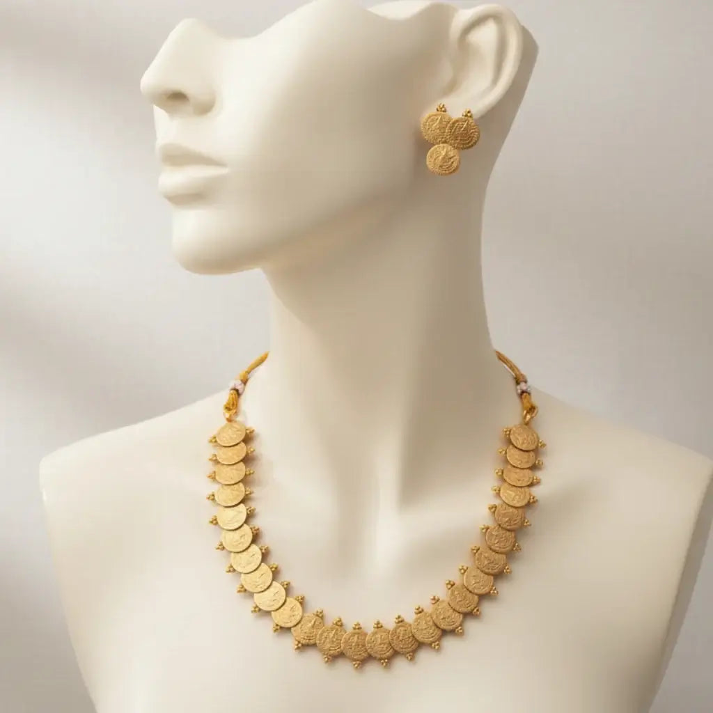 Antique Lakshmi Kasumala Necklace Set displayed on a mannequin with matching earrings, showcasing intricate coin motifs.