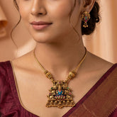 Antique Lakshmi Elephant Temple Pendant Necklace Set displayed on a model, featuring intricate designs and colorful meenakari work.