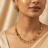 Antique Gold-Plated Leaves Necklace Set worn with matching stud earrings, showcasing elegant design and textured finish.