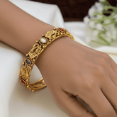 Antique Gold-Plated Peacock 5-Colour Stone Bangle worn on a hand, showcasing vibrant multi-colour stones and detailed design.