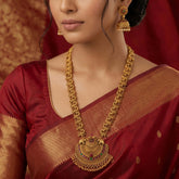 Antique Peacock Kemp Stone Long Chain Set worn with a traditional red saree featuring intricate gold detailing.