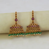Antique Gold Ruby Red Kemp Stone Jhumka Earrings with green crystals and intricate detailing.
