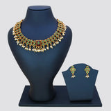 Antique White Pearls Hanging Stone Necklace Set with matching earrings displayed on a stand.