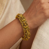 Antique Gold Plated Lakshmi Kada Bangle showcased on a hand, featuring intricate Goddess Lakshmi designs.