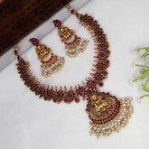 Antique Lakshmi Kemp Stone Mango Necklace Set with pearl beads, arranged on a white surface with decorative props.