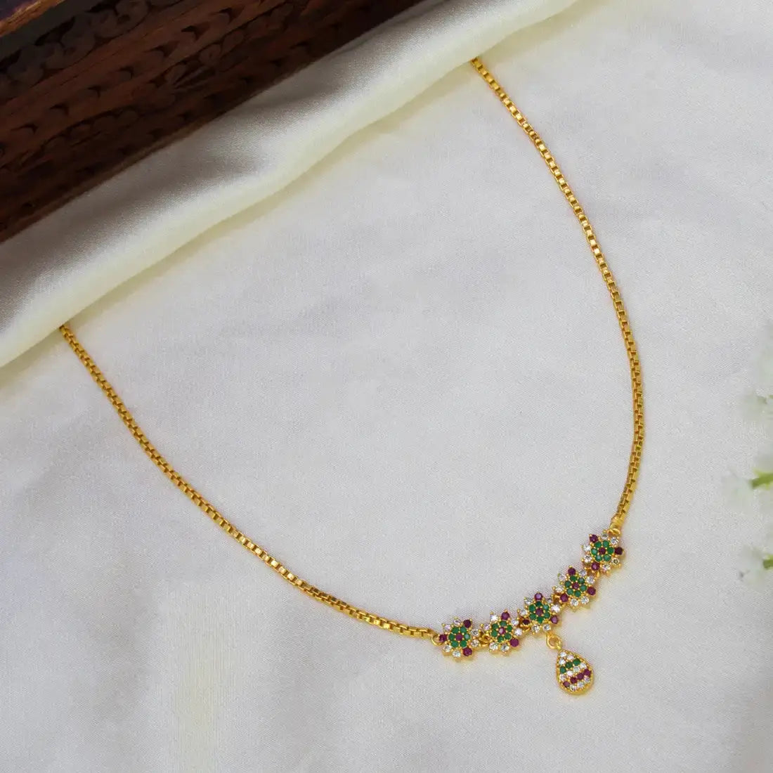 Gold-Plated Multicoloured Stone Floral Short Necklace featuring vibrant stones and floral design on a golden chain.