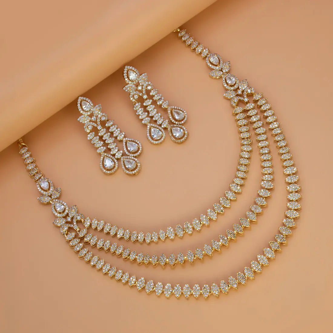 American Diamond necklace and earrings on a peach background