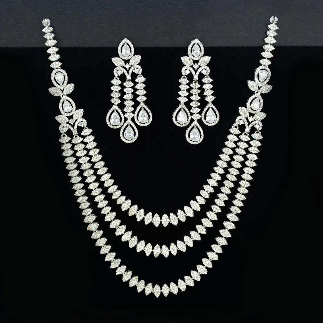American Diamond necklace and earrings set on a black background