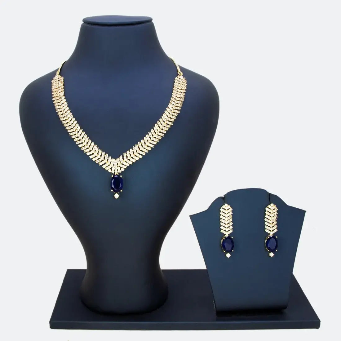 Gold-Plated American Diamond Necklace Set showcasing wide chevron-pattern design with royal blue center stone and matching earrings.