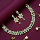 Grand Gold Plated CZ Pastel Green Necklace Set with floral designs and sparkling stones on a purple background.