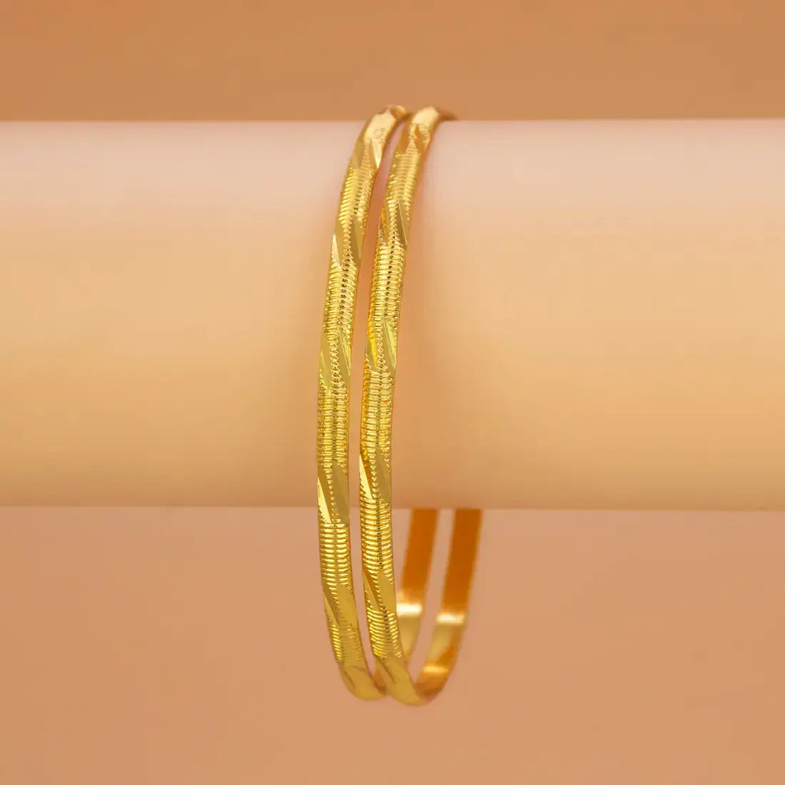 Casual Gold Plated MC Mayoori Bangles showcasing a slim design with textured grooves and smooth finishes.