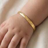 Kada-Style Gold Plated Bangle for Baby Boys worn on a baby's wrist.