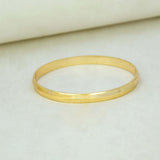 Kada-Style Gold Plated Bangle for Baby Boys resting on a soft surface, showcasing its elegant design.