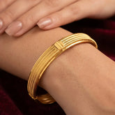 Contemporary Gold Plated Multi Spring Design Bangle worn on wrist, showcasing intricate design and luxurious gold finish.