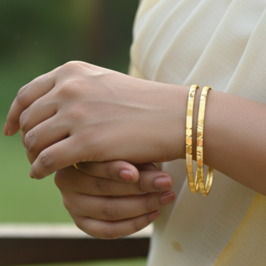 Elegant hand wearing Contemporary Gold Plated Designer Cutting Bangles, showcasing the diamond-cut design.