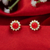 Gold-Plated Coral And Pearl Flower Studs featuring red coral center and white pearls on a red fabric background.