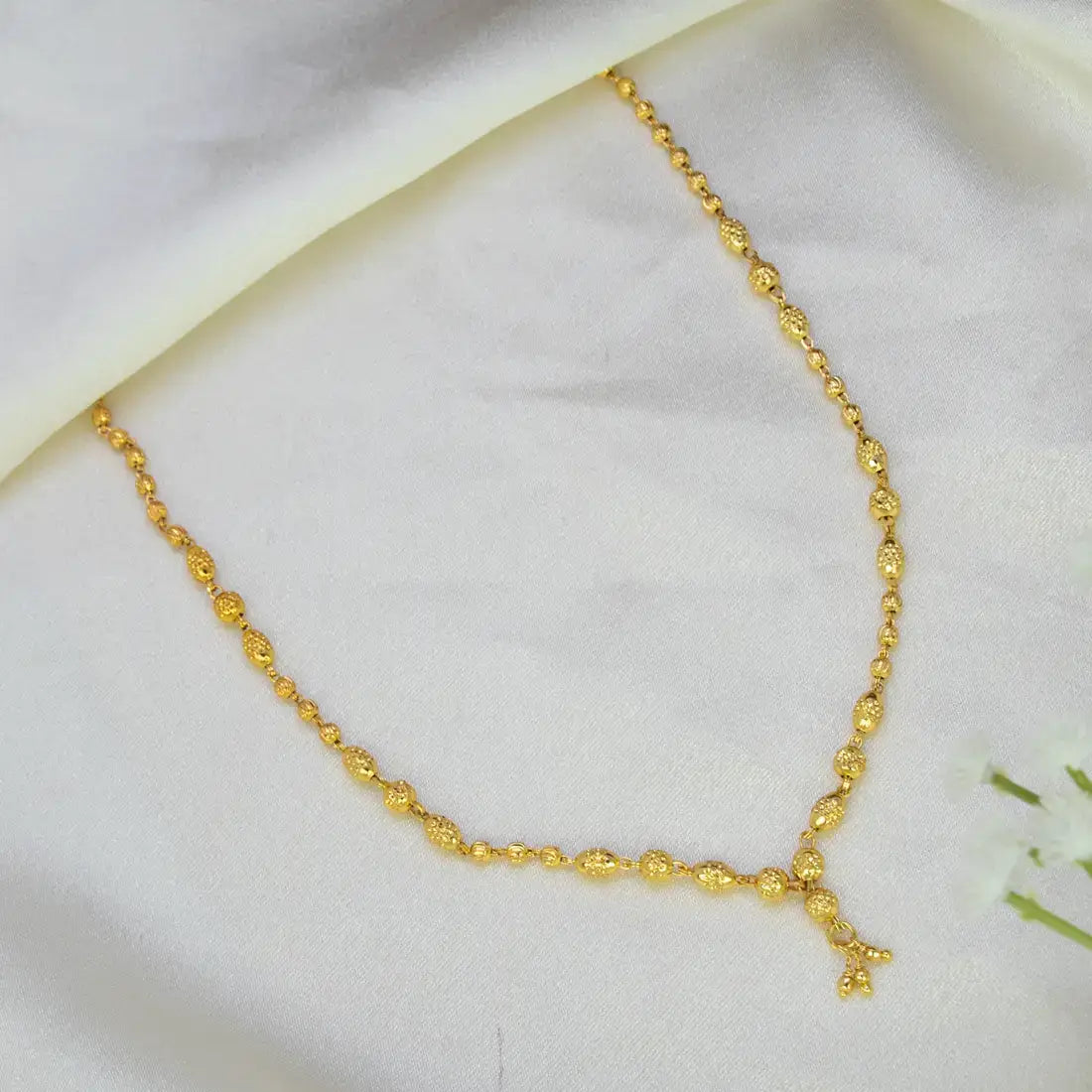 Simple Gold-Plated Textured Bead Necklace featuring granulated beads on a silky backdrop.