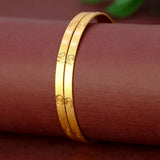 Elegant Matte Gold Plated Designer Bangles on a display surface, showcasing their smooth finish and elegance.