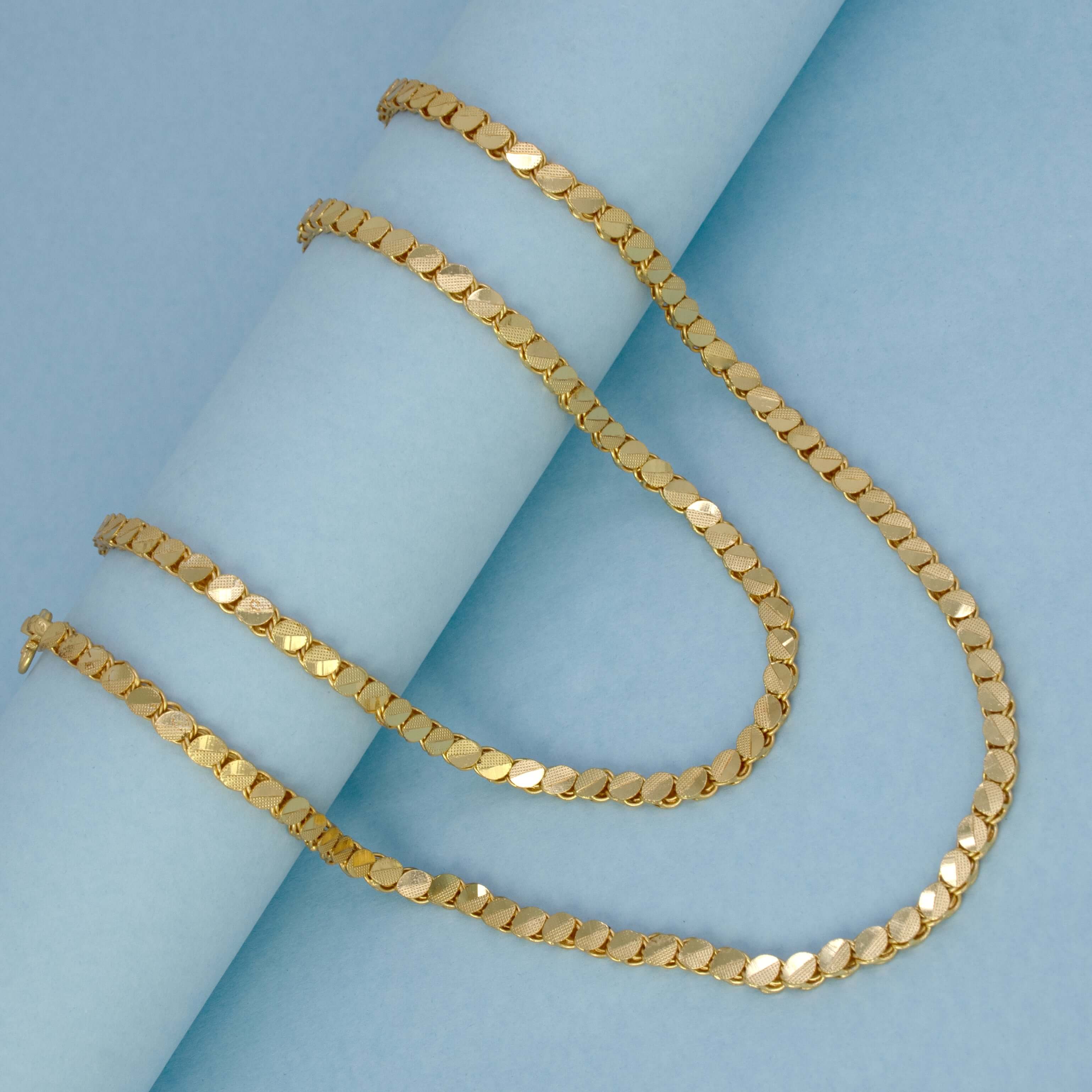 Elegant Designer Gold Plated Chain -10 P displayed on a blue background, showcasing its unique oval disc pattern.