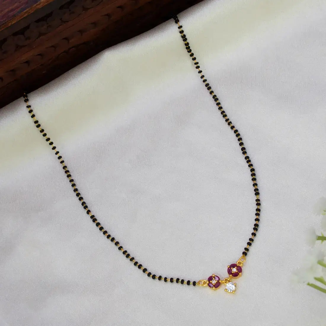 Floral Stone Pendant Black Beads Mangalsutra Chain featuring black beads and vibrant ruby stones.