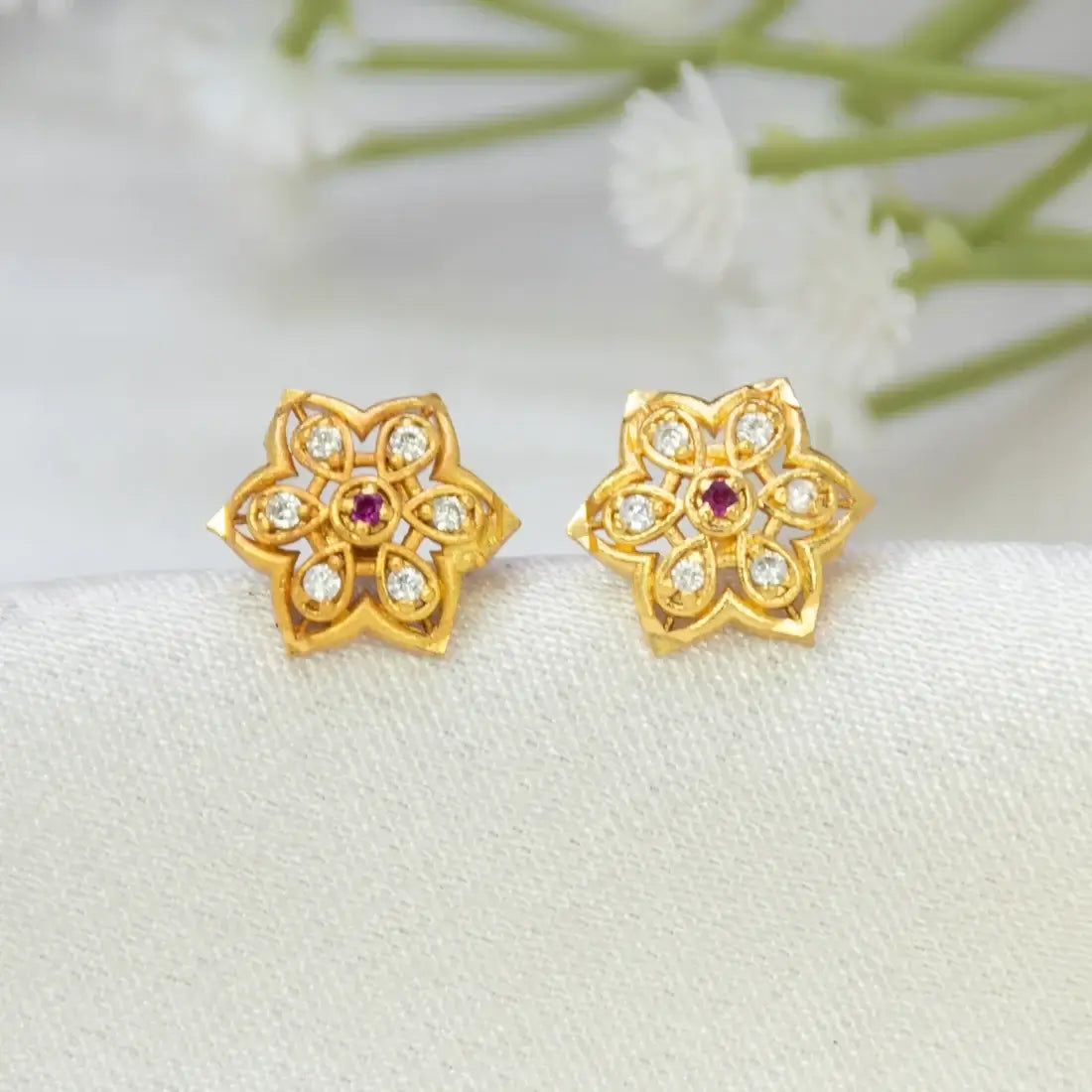 Floral CZ Stone Gold Plated Stud Earrings featuring a floral design with CZ stones and a ruby accent.