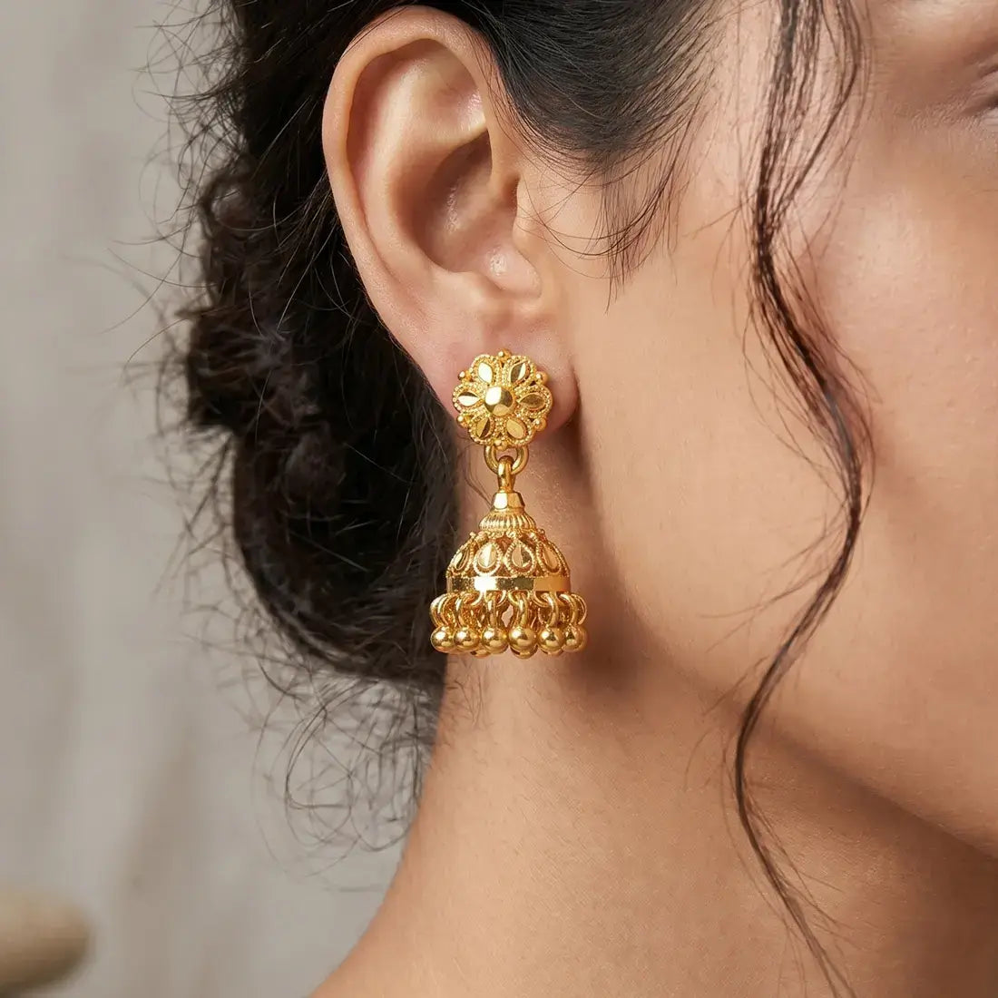 Gold-Plated Small Floral Jhumka Earrings showcasing a floral stud top and cascading polished gold ball drops.