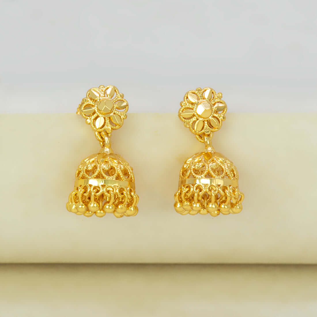 Gold-Plated Small Floral Jhumka Earrings showcasing intricate filigree design and elegant bell drop in gold.