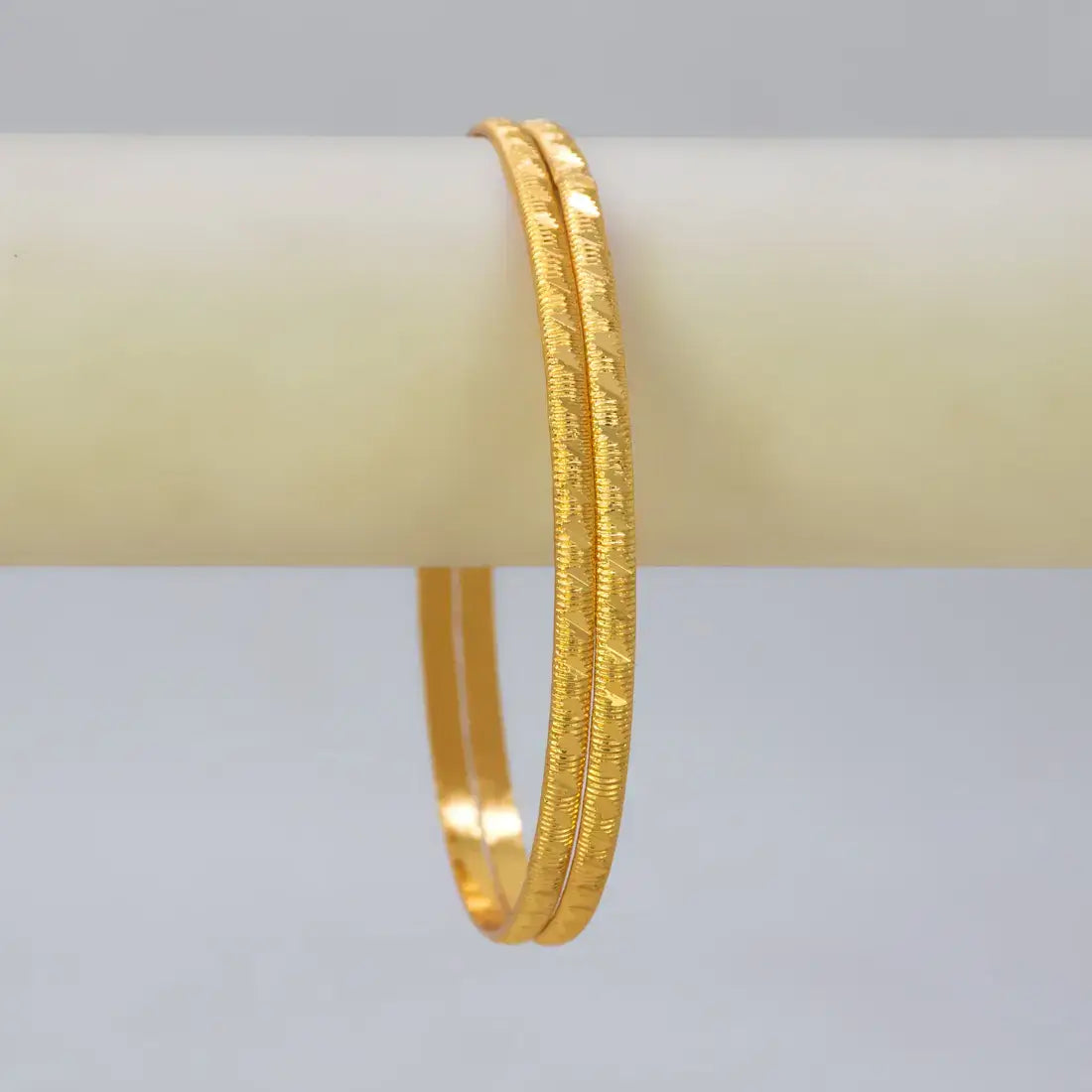 Lightweight Gold Plated Indian Bangles for Women on display, showcasing a classic design with a simple diamond cut.