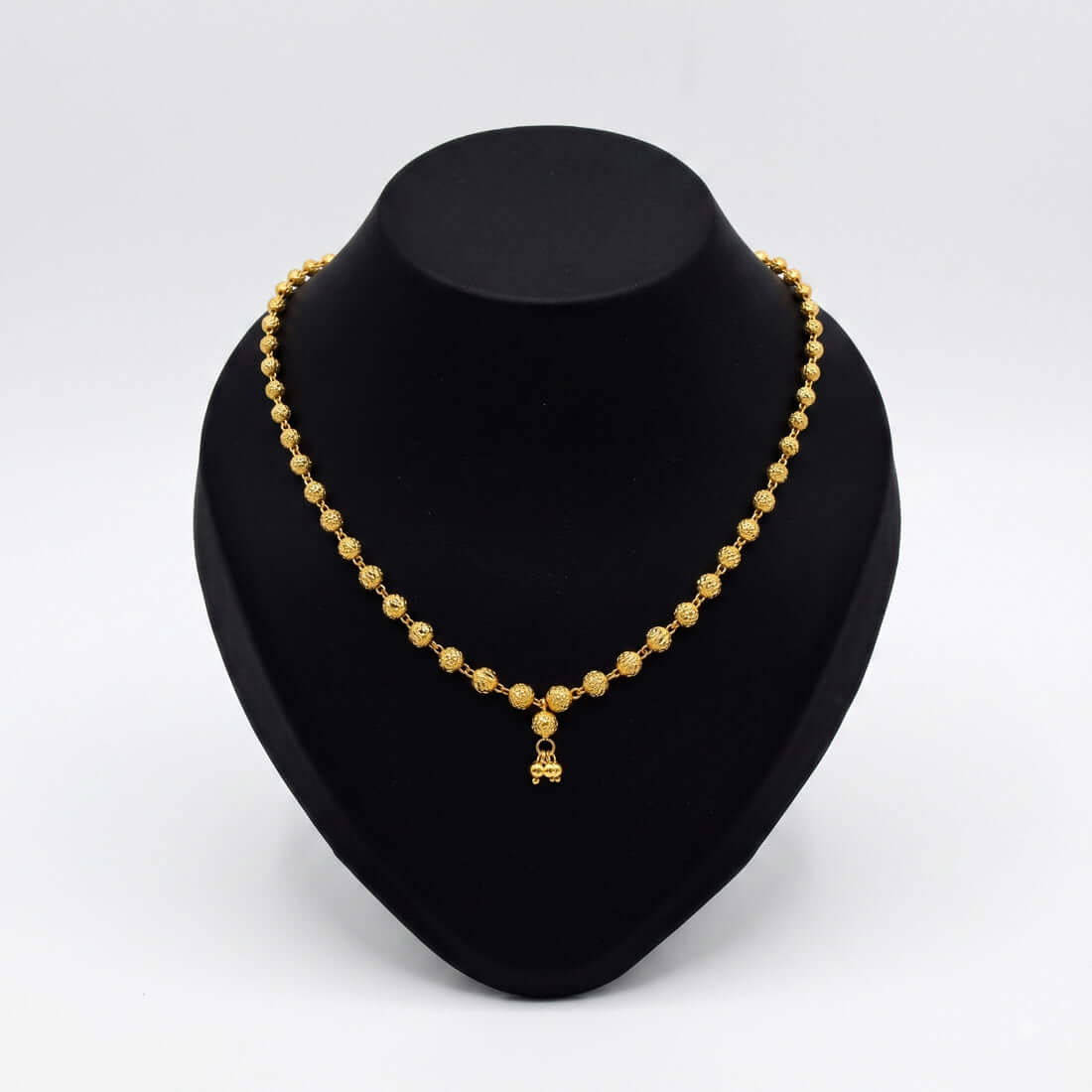 Gold Plated Designer Ball Chain Necklace displayed elegantly on a black jewelry stand.