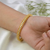 Gold Plated CZ Stone Net Design Bangle on a woman's wrist with sparkling stones and elegant detailing.