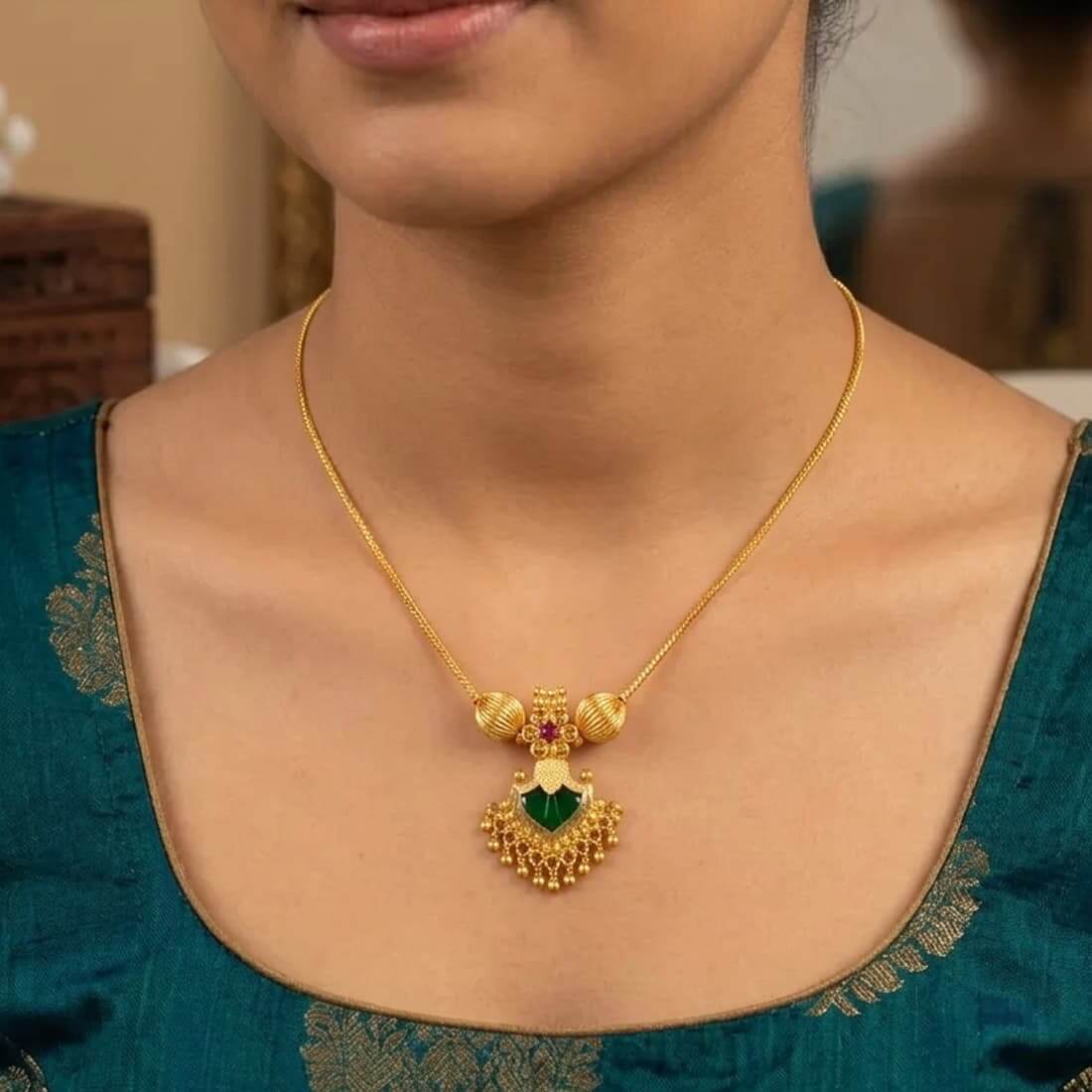 Gold-Plated Green Palakka Pendant Necklace worn by a model, showcasing intricate design and rich green palakka stone.